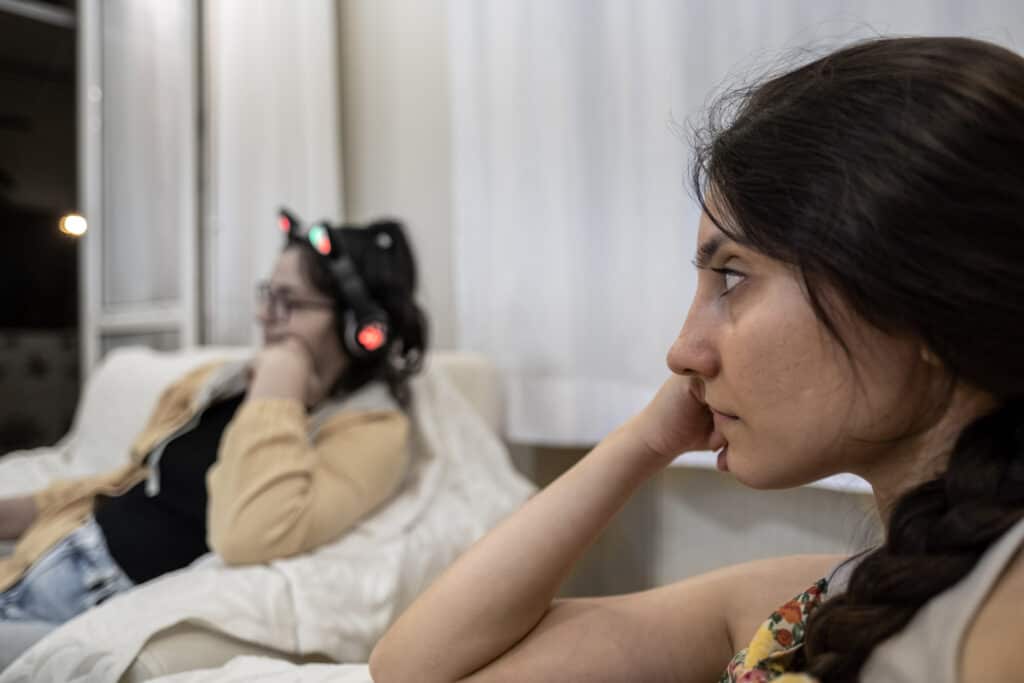 Two Sisters Ignoring Each Other Two sisters ignoring each other, in a dysfunctional relationship rather than forgiving each other.