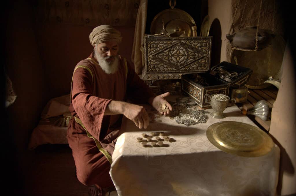 Matthew the tax collector counting coins before he followed Jesus