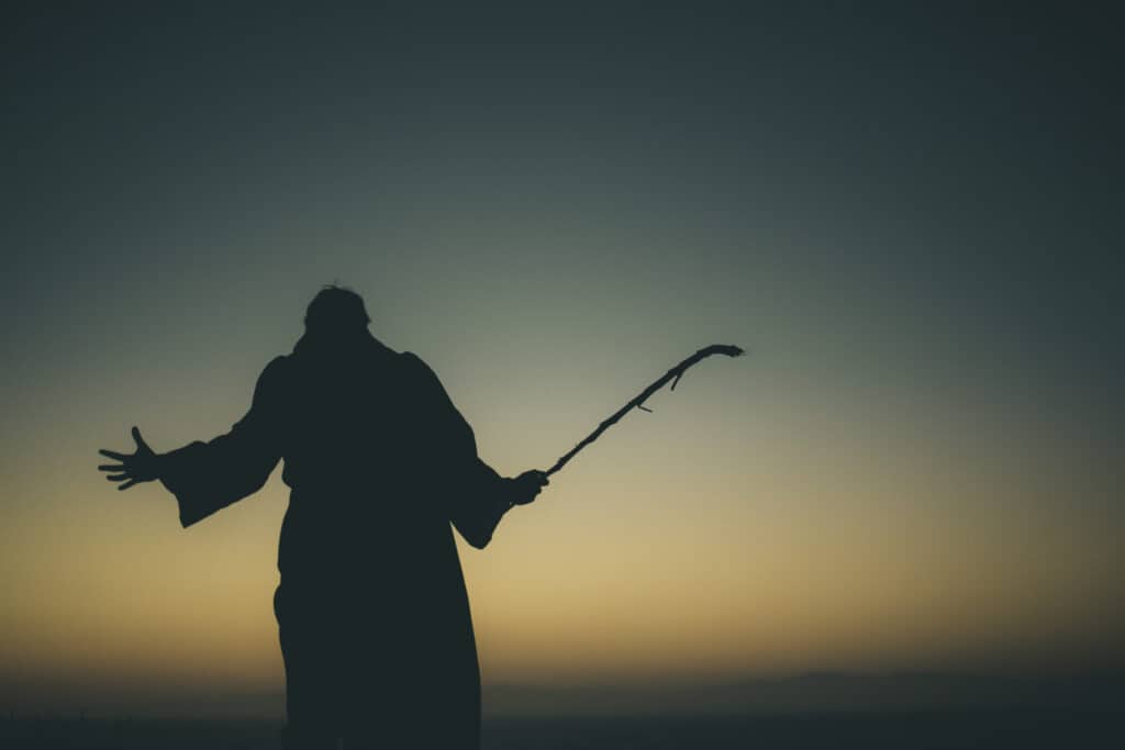 Silhouette of Moses speaking to the people instead of the rock as God instructed him.